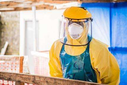 A healthcare worker in protective gear is seen at an Ebola treatment center in the west of Freetown, Sierra Leone, Thursday, Oct. 16, 2014. The deadly Ebola virus has infected two people in what was the last untouched district in Sierra Leone, the government said Thursday, a setback in efforts to stop the spread of the disease in one of the hardest-hit countries. (AP Photo/Michael Duff)