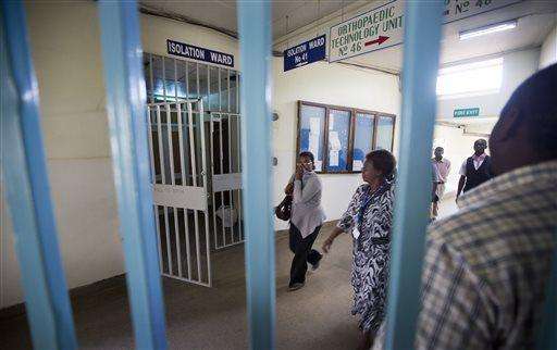 In this Oct. 8, 2014 photo, hospital visitors walk past the locked entrance to an isolation ward at the Kenyatta National Hospital in Nairobi, Kenya. Health officials battling the Ebola outbreak that has killed more than 4,500 people in West Africa have managed to limit its spread on the continent to five countries. Health officials battling the Ebola outbreak that has killed more than 4,500 people in West Africa have managed to limit its spread on the continent to five countries, with Kenya so far escaping the virus. (AP Photo/Ben Curtis)