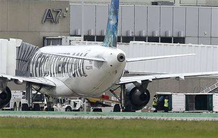 Caption: Two workers unload bags from the Frontier Airlines plane that Amber Joy Vinson flew from Cleveland to Dallas on Monday, at a terminal at Cleveland Hopkins International Airport Wednesday, Oct. 15, 2014, in Cleveland. Vinson is the second nurse to be diagnosed with Ebola at the Texas Health Presbyterian Hospital in Dallas. Ohio health officials aren't sure how many people came into contact with Vinson as she visited family in the Akron area days before being diagnosed with the disease. (AP Photo/Tony Dejak)