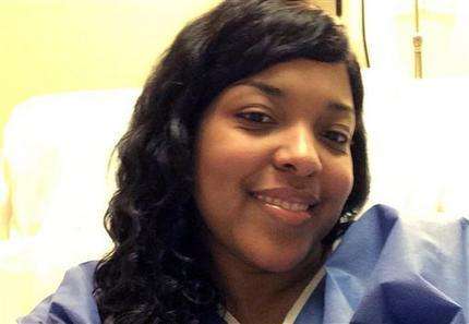 This Oct. 21, 2014, file photo, provided by Amber Vinson, shows Vinson at Emory University Hospital in Atlanta. Vinson, a Dallas nurse who was being treated for Ebola, will attend a news conference, Tuesday, Oct. 28, 2014, to discuss her discharge from the hospital after tests showed she's virus-free. (AP Photo/Amber Vinson, File)