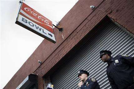 In this Oct. 24, 2014, file photo, police officers stand outside The Gutter bowling alley after it was closed when it was discovered it had been visited by Craig Spencer, a Doctors Without Borders physician who tested positive for the Ebola virus, in the Williamsburg neighborhood of the Brooklyn borough of New York. After Spencer was settled at a hospital, New York department of health workers reconstructed in detail his movements in the days since his return form Guinea where he was treating patients with Ebola. They combined information from his Metrocard, phone records and friends to paint a picture of his days and to assess whether anyone else may have been exposed and found that he had visited the bowling alley. (AP Photo/John Minchillo, File)