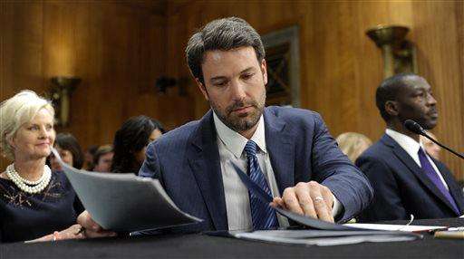  
              FILE - In this Feb. 26, 2014 file photo, actor and Eastern Congo Initiative Founder Ben Affleck, center, puts down his opening remarks during a Senate Foreign Relations Committee hearing on the Congo, on Capitol Hill in Washington.   Bono, Matt Damon, Affleck and Morgan Freeman are among the celebrities who are playing the waiting the game in a new online campaign calling for a unified response from the world's leaders to the Ebola epidemic in West Africa. In a video posted Wednesday, Nov. 19, 2014, stars such as Will Ferrell, Thandie Newton and Connie Britton stare silently into a camera to illustrate that they're still waiting for the world's leaders to act on fighting Ebola, which has killed more than 5,000 people in the west African countries of Sierra Leone, Guinea and Liberia. (AP Photo/Susan Walsh, File)
             