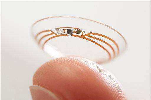 This undated photo released by Google shows a contact lens Google is testing to explore tear glucose. After years of scalding soldering hair-thin wires to miniaturize electronics, Brian Otis, Google X project lead, has burned his fingertips so often that he can no longer feel the tiny chips he made from scratch in Google’s Silicon Valley headquarters, a small price to pay for what he says is the smallest wireless glucose sensor that has ever been made. (AP Photo/Google)