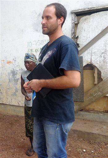  
              In this August 2013 photo, Rhode Island native Ashoka Mukpo speaks with residents of an iron ore mining camp in Bong County, Liberia. Mukpo, who was diagnosed with Ebola in Liberia Thursday, Oct. 2, 2014, was flow Monday, Oct. 6, 2014, to Omaha, Neb., for treatment. (AP Photo/The Providence Journal, Philip Marcelo) MANDATORY CREDIT. RHODE ISLAND OUT. NO SALES.
             