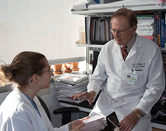 MD/Ph.D. student Julia Warren discusses her research into a new approach to designing treatments for autoimmune disorders and bone loss with her mentor and co-author, Steven Teitelbaum, MD. (Source: WUSTL/Michael C. Purdy)