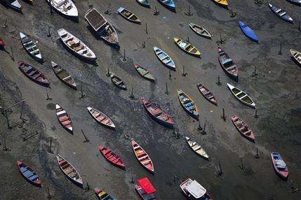 In this Nov. 19, 2013 file photo, small boats sit on the polluted shore of Guanabara Bay in the suburb of Sao Goncalo, across the bay from Rio de Janeiro, Brazil. A drug-resistant “super bacteria” that’s normally found in hospitals and is notoriously difficult to treat has been discovered in the waters where Rio de Janeiro’s Olympic sailing events will be held, scientists with Brazil’s most respected health research institute said Monday, Dec. 15, 2014. (AP Photo/Felipe Dana)